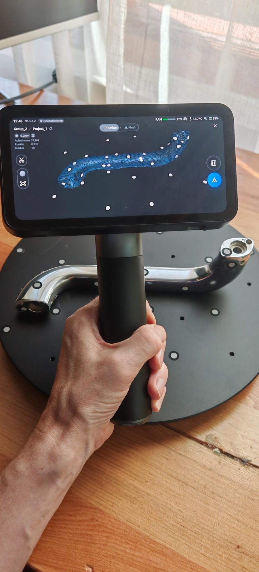 Our handheld 3D scanner over one of the original chrome bathtub handles, the scan building up on its screen